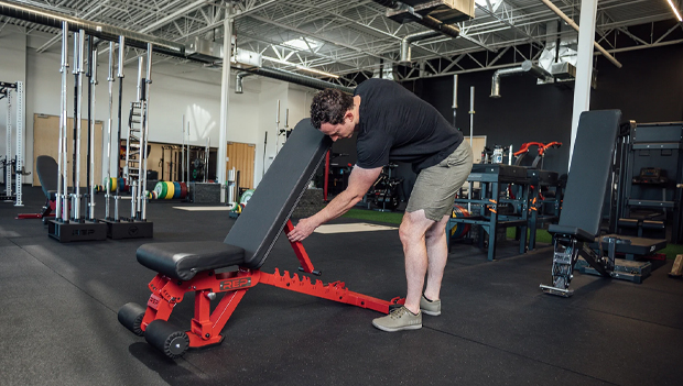 man using adjustable weight bench