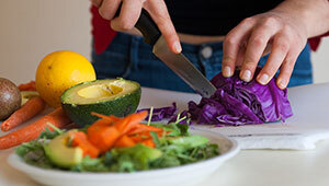 person chopping vegetables